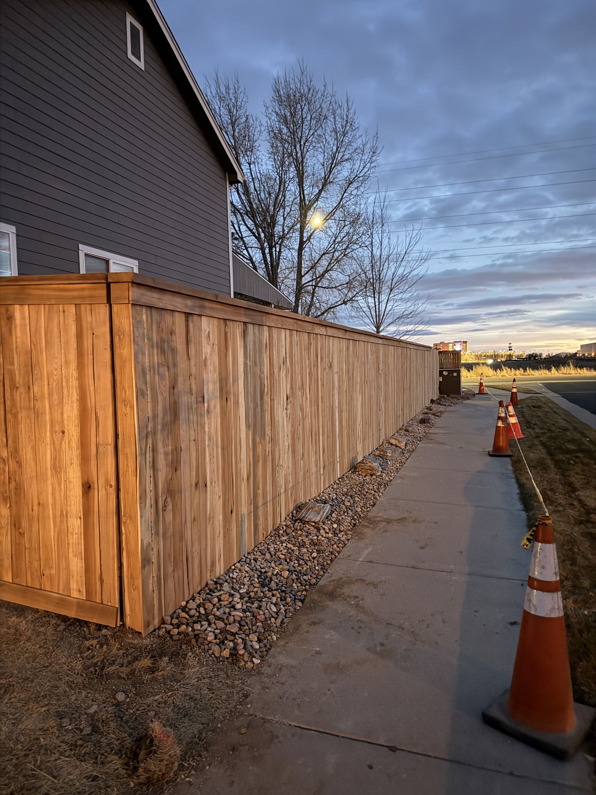 Cedar privacy fence with rock drain line