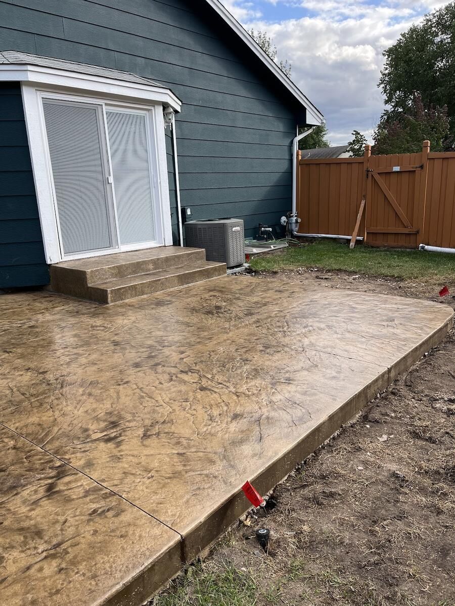 Tan stamped concrete patio with steps